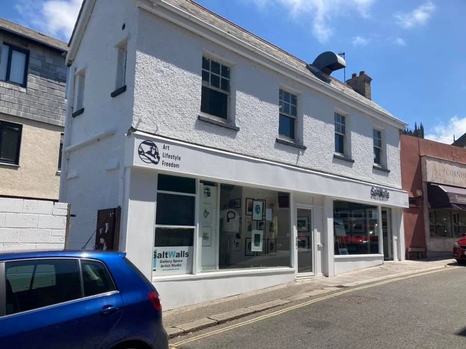 Angled view of a finished commercial shopfront repaint on a Swansea street