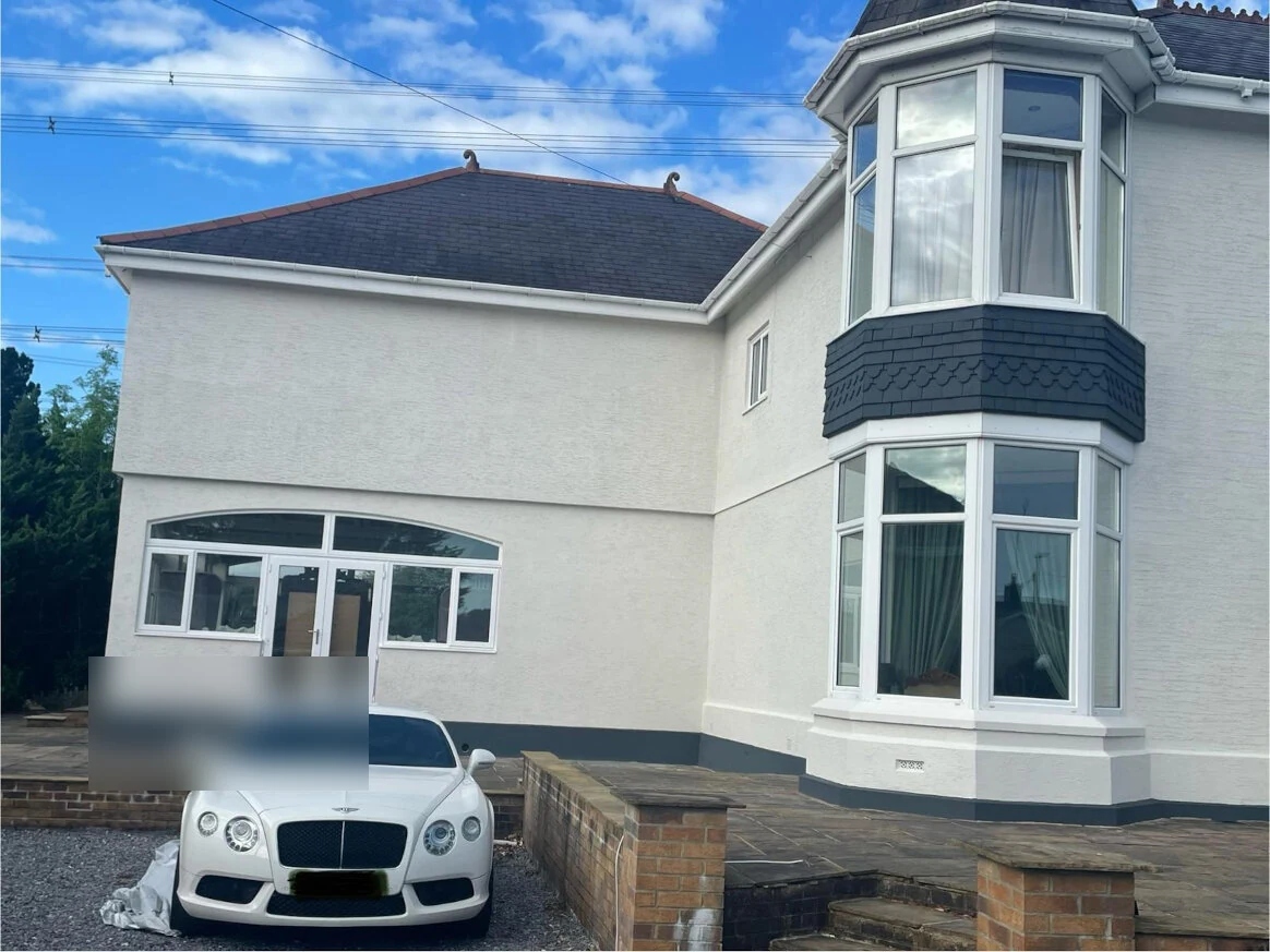 207-painted-bay-window-exterior-with-vehicle-in-foreground-swansea-daffodil-property-refurbishment Bay-fronted Swansea house after its exterior was repainted white