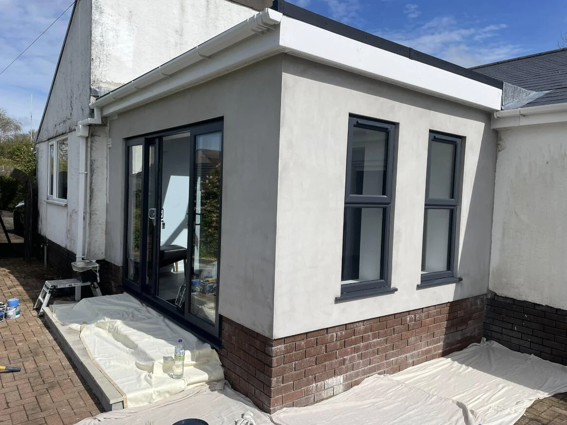 208-modern-rear-extension-still-surrounded-by-decorating-materials-swansea-daffodil-property-refurbishment Finished modern rear extension with black-framed glazing on a Swansea house