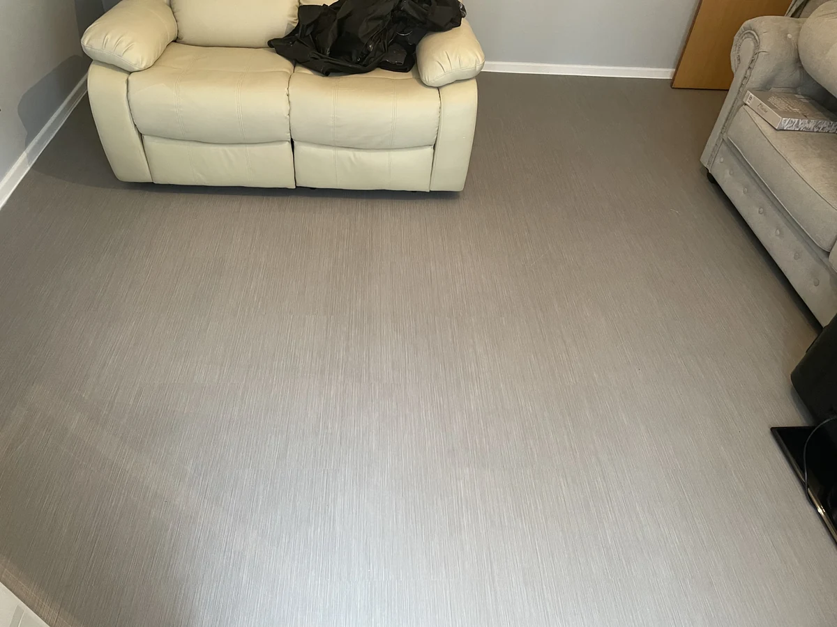 386-finished-flooring-in-furnished-lounge-with-jacket-and-household-clutter-swansea-daffodil-property-refurbishment New flooring finished in a furnished Swansea lounge