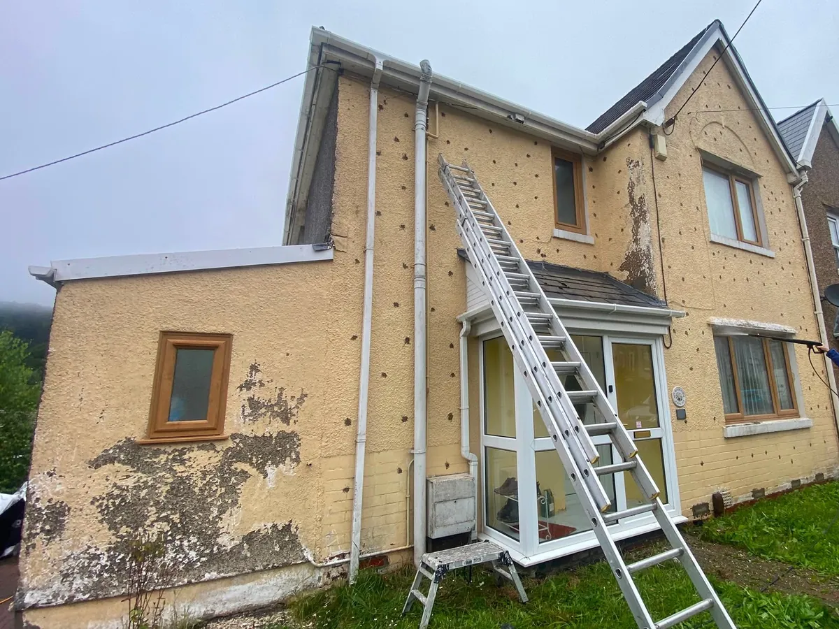 505-exterior-rendering-in-progress-with-ladders-and-worker-swansea-daffodil-property-refurbishment Ladders up and a worker part-way through re-rendering the outside of a Swansea house