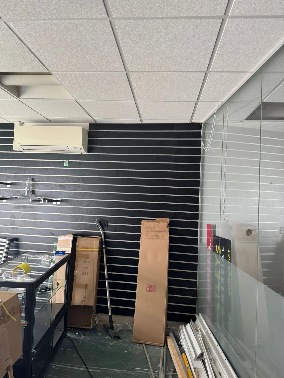 Finished black slatwall feature wall inside the Wimozee Technology shop fit-out, Morriston